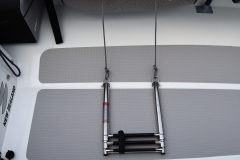 Ladder is stored inside the storage bag under the deck, once you take the ladder out you can flick it over the deck and extend it .